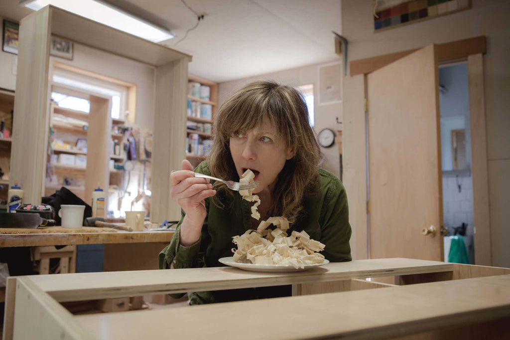 Nancy Hiller pretending to eat wood shavings